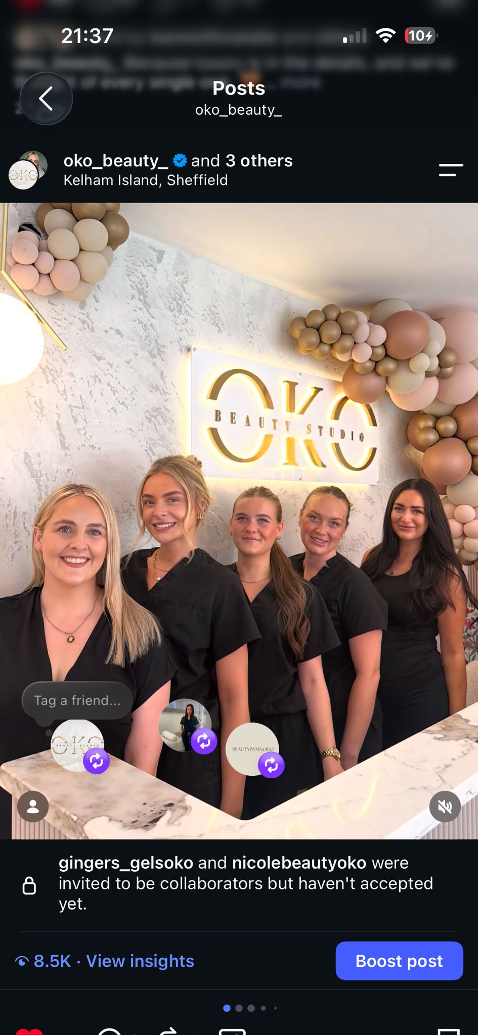 Five members of the OKO team beneath the illuminated OKO Beauty Studio sign
