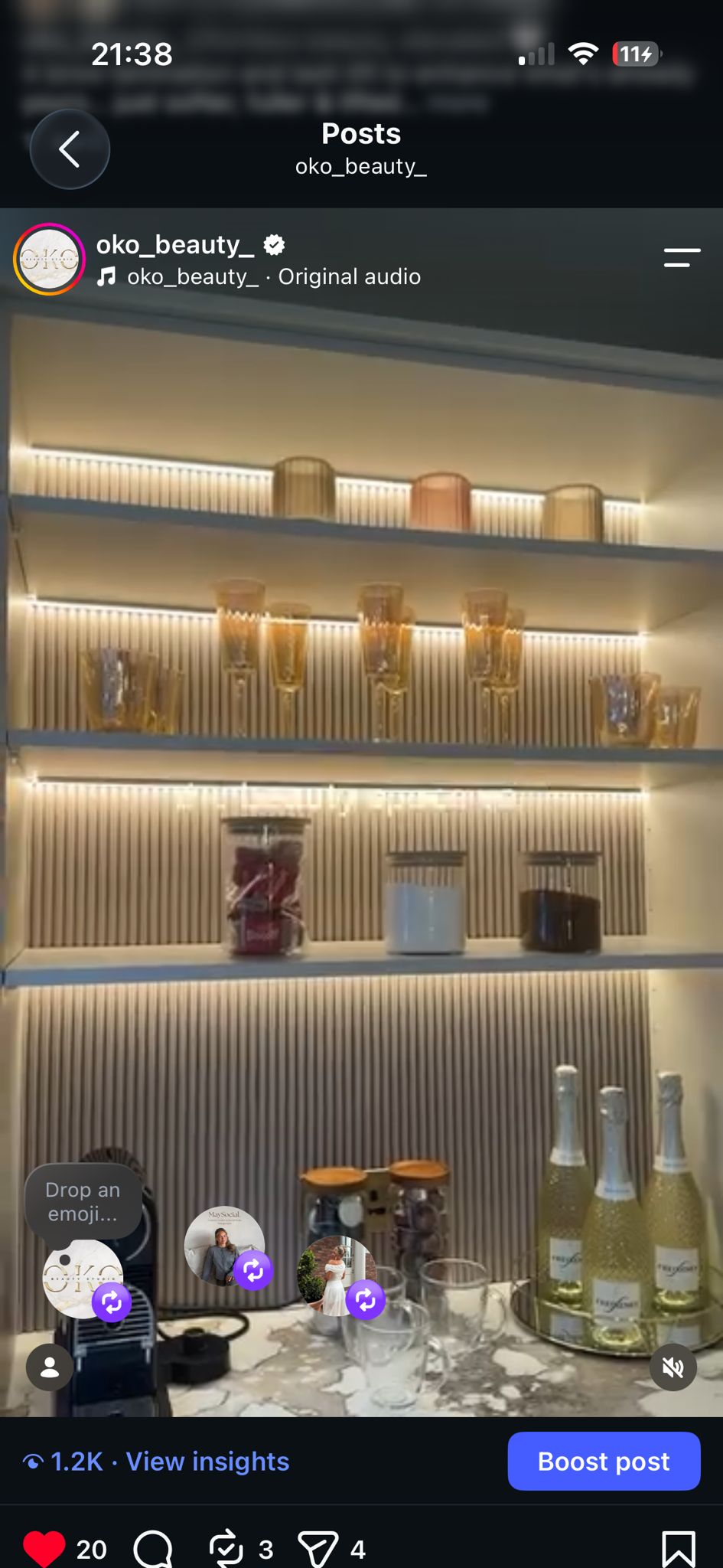 Warmly illuminated shelving and glassware in the salon